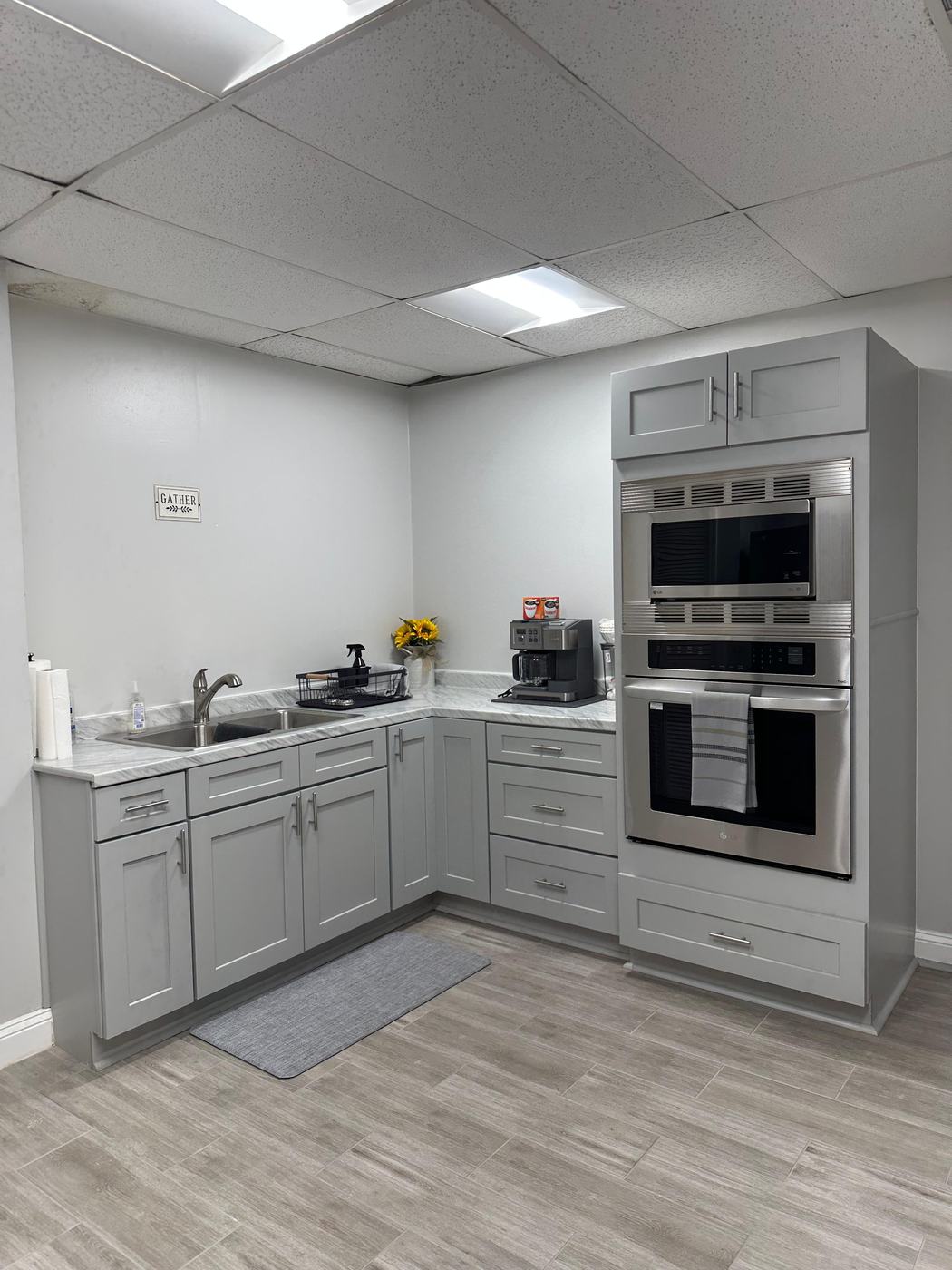 Kitchen with gray cabinets and double wall oven