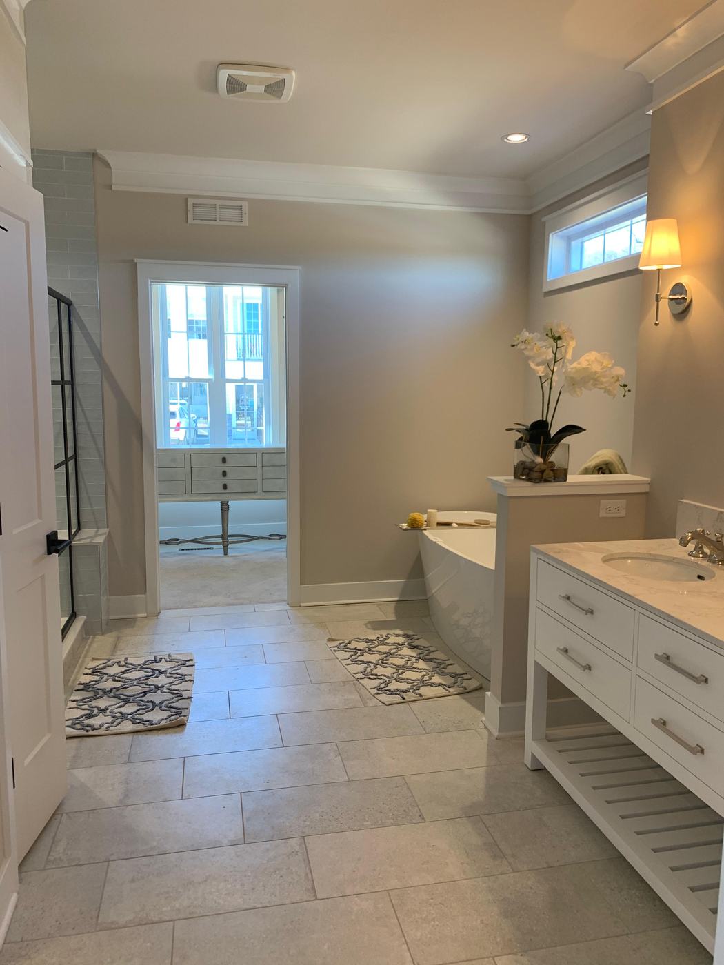 Primary bathroom with white vanity