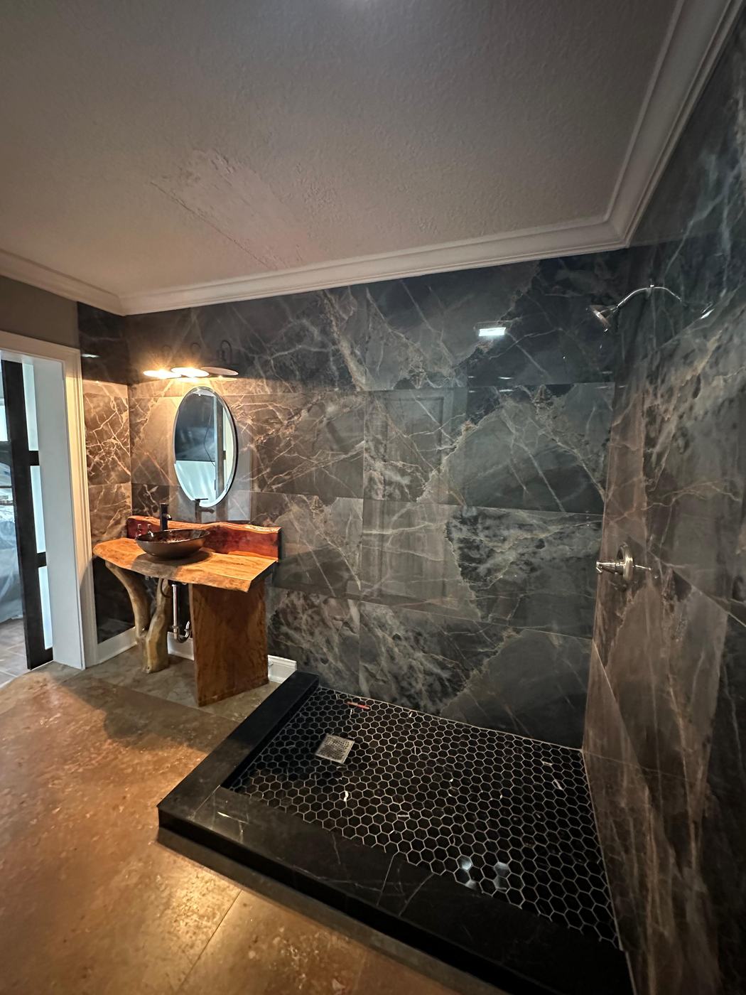 Bathroom with live-edge wood vanity and dark marble walls